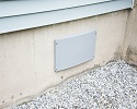 A crawl space vent being sealed by our vent covers