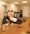 a basement gym and workout room with a wood laminate flooring, installed in Massey Drive, NL